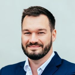 Markus Giesen, wearing a fancy blue suit, a starched collar shirt, much corporate, very uniform.